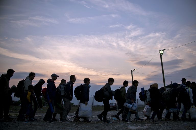 Migrants and refugees queue at a camp to be register after crossing the Macedonian-Greek border near Gevgelija on September 22, 2015. More than 300,000 migrants have arrived by sea in Greece since January, the majority of whom continue their journey through Macedonia and Serbia on their way to EU countries Hungary and Croatia. AFP PHOTO / NIKOLAY DOYCHINOV